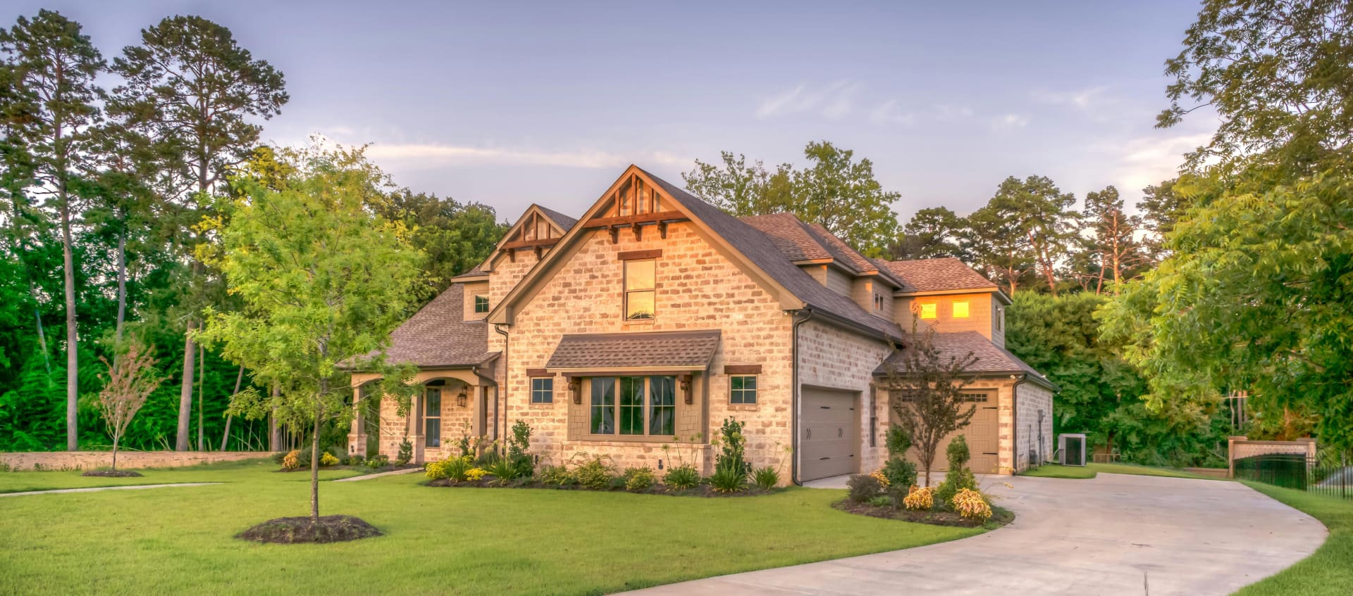 A house with a driveway and trees.