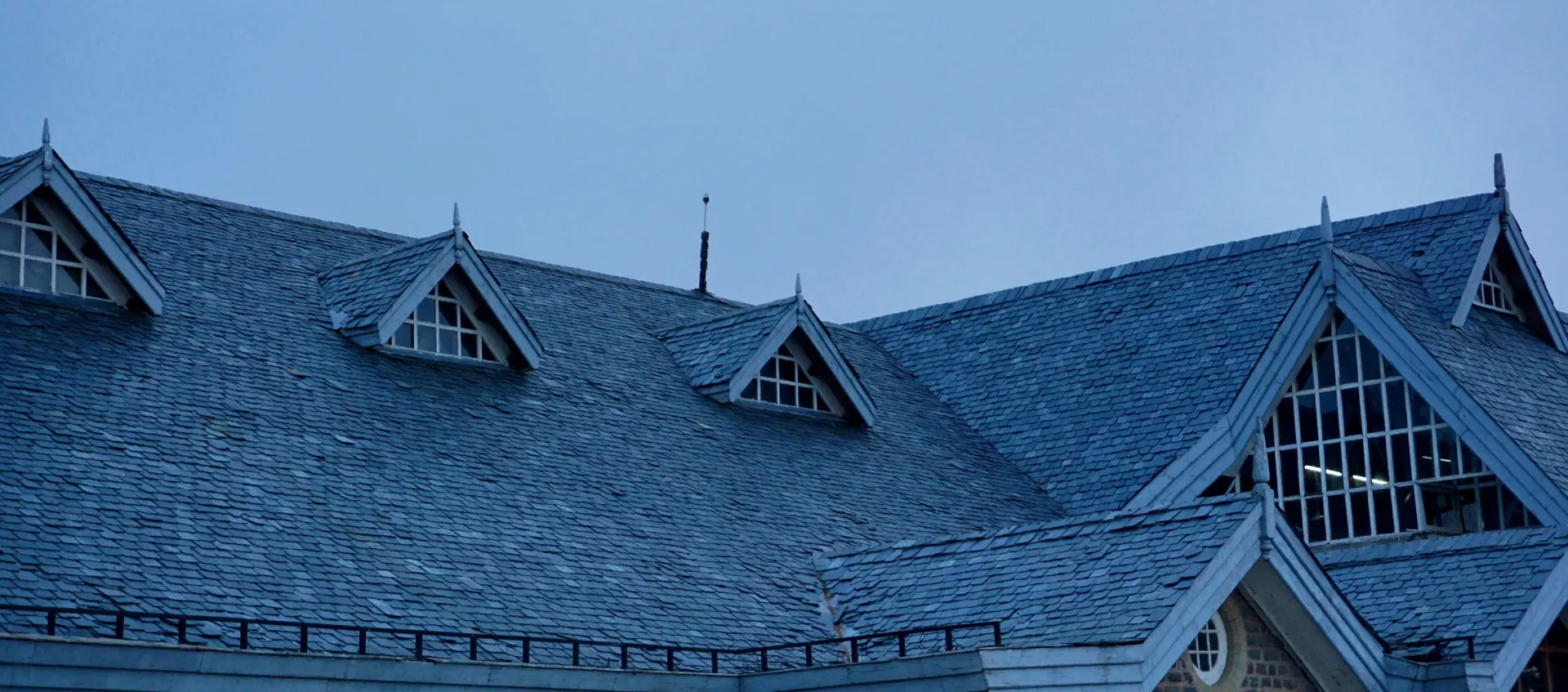 The roof of a building with many windows.